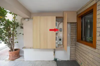 a door of a house with a red sign on it at illusion 1 in Piraeus