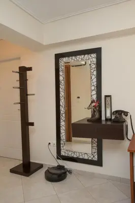 a mirror on a wall in a room at illusion 1 in Piraeus
