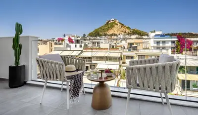 a balcony with two chairs and a table with a view at Urban K in Athens
