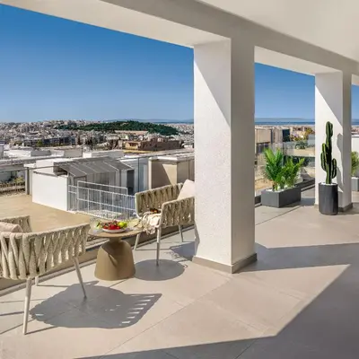 a balcony with chairs and a view of the city at Urban K in Athens