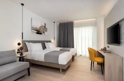 a hotel room with a bed and a tv and a couch at Urban K in Athens