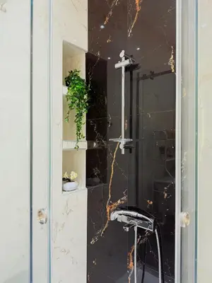 a glass shower with a stool in a bathroom at Casa Marina in Athens