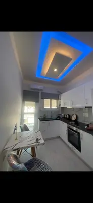 a kitchen with a blue light on the ceiling at City apartment in Athens