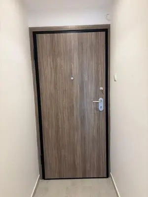 a wooden door in the corner of a room at City apartment in Athens