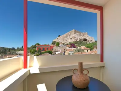 a window with two vases sitting on a table in a room at The Acropolis Window in Athens