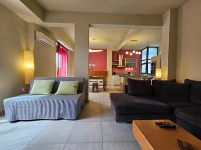 a living room with a couch and a table at Ilissos Terrace Apartment in Athens