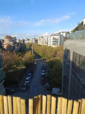 a city street with cars parked in a parking lot at Ilissos Terrace Apartment in Athens