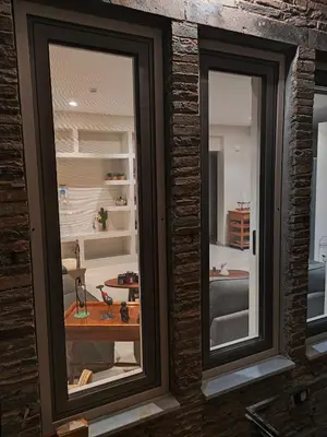 a room with two windows and a living room at Thalia in Athens
