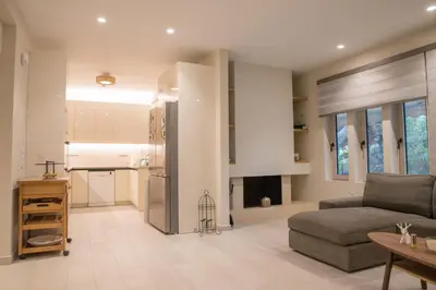 a living room with a couch and a kitchen at Thalia in Athens