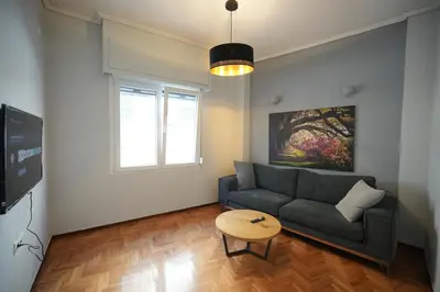 a living room with a couch and a table at Cozy Exarcheia, 1 BDRM central Apartment in Athens