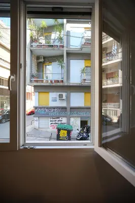 an open window with a view of a building at Cozy Exarcheia, 1 BDRM central Apartment in Athens