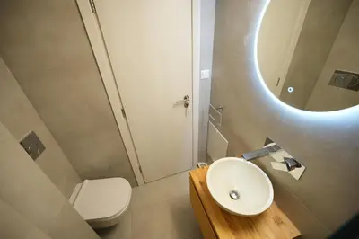 a bathroom with a sink and a toilet and a mirror at Cozy Exarcheia, 1 BDRM central Apartment in Athens