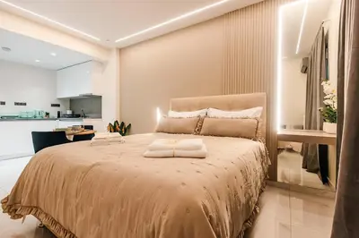 a bedroom with a bed with two towels on it at Sunset luxury studio by the sea in Athens