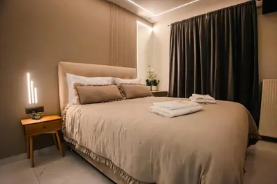 a bedroom with a bed with two towels on it at Sunset luxury studio by the sea in Athens