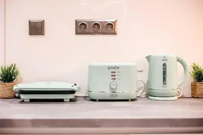 two coffeemakers sitting on a counter in a kitchen at Sunset luxury studio by the sea in Athens