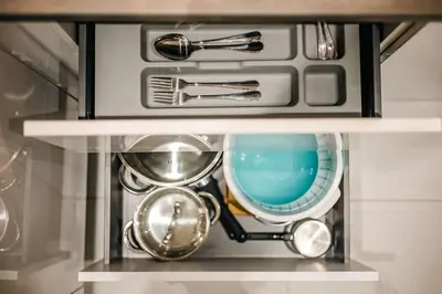 a drawer filled with dishes and utensils at Sunset luxury studio by the sea in Athens