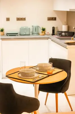 a table with plates and glasses on it in a kitchen at Sunset luxury studio by the sea in Athens