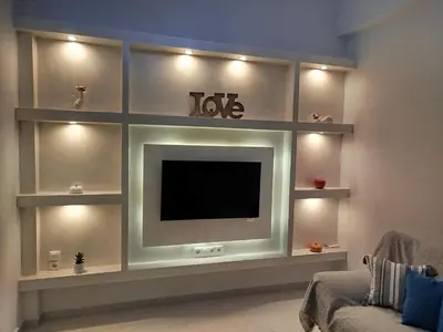 a living room with a flat screen tv on a wall at Cuka apartment 3BD nexto to metro and Piraeus Port in Piraeus