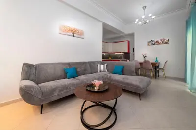 a living room with a couch and a table at Cuka apartment 3BD nexto to metro and Piraeus Port in Piraeus