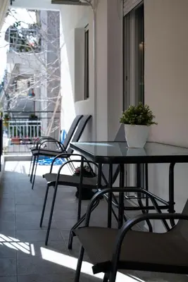 a group of tables and chairs on a balcony at Cuka apartment 3BD nexto to metro and Piraeus Port in Piraeus