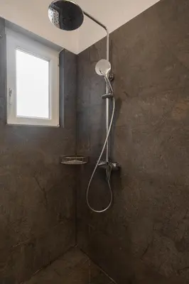 a shower in a bathroom with a window at Quiet Studio In The Heart of Athens in Athens