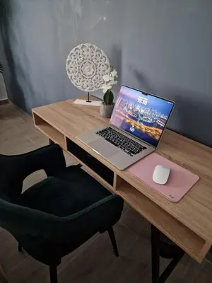 a laptop computer sitting on a wooden desk with a chair at Modern Athens Apartment - Close to Metro in Athens