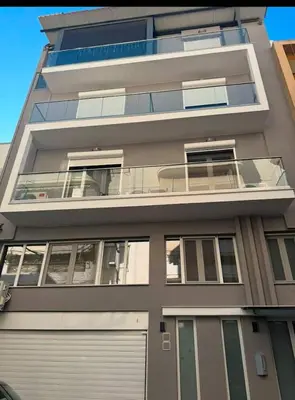 an apartment building with a door and a garage at Modern Athens Apartment - Close to Metro in Athens