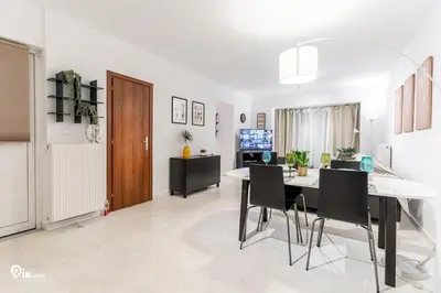 a dining room with a table and black chairs at Olympian Zeus - Premium & Luxury Athenian House in Athens