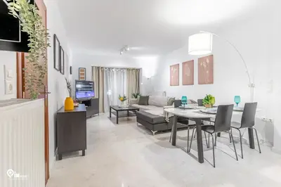 a living room with a table and a dining room at Olympian Zeus - Premium & Luxury Athenian House in Athens