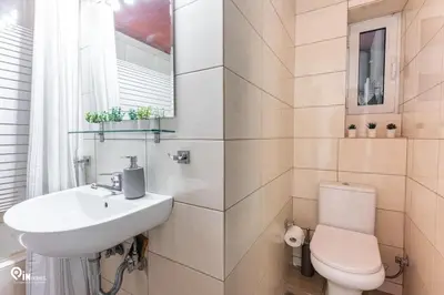 a white bathroom with a sink and a toilet at Olympian Zeus - Premium & Luxury Athenian House in Athens