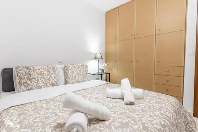 a bedroom with a bed with towels on it at Olympian Zeus - Premium & Luxury Athenian House in Athens