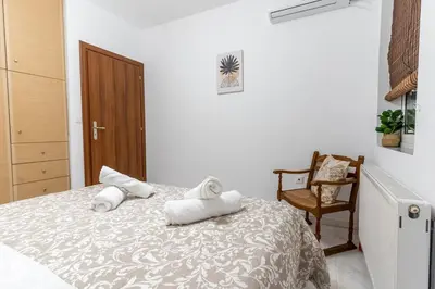 a bedroom with a bed with two pillows on it at Olympian Zeus - Premium & Luxury Athenian House in Athens