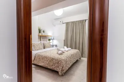 a bedroom with a bed with two pillows on it at Olympian Zeus - Premium & Luxury Athenian House in Athens