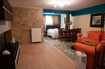 a living room with a couch and a bedroom at Apartment Margarita in Athens