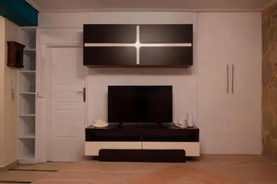 a living room with a flat screen tv on a wall at Apartment Margarita in Athens