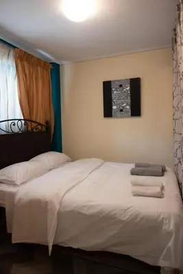 a bedroom with a bed with towels on it at Apartment Margarita in Athens