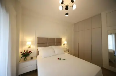a bedroom with a large white bed with flowers on it at Apartment Cathrine in Athens