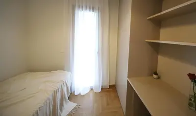 a bedroom with a white bed and a window at Apartment Cathrine in Athens