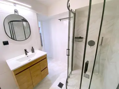 a bathroom with a shower and a sink and a mirror at MediTerra Stay Athens Park Place in Athens