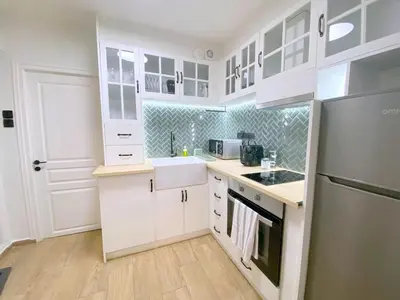 a white kitchen with a sink and a refrigerator at MediTerra Stay Athens Park Place in Athens