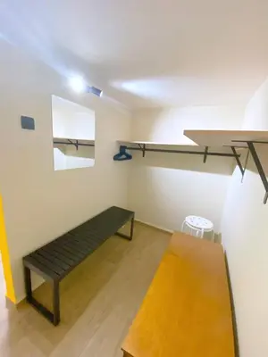 a room with a bench and a shelf on the wall at MediTerra Stay Athens Park Place in Athens
