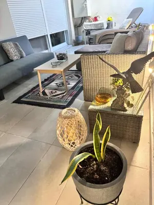 a living room with a plant in a pot at Luxury 2 storey 2bedroom condo with Private Jacuzzi & patio - Athens in Athens