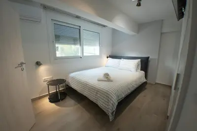 a bedroom with a bed with a stuffed animal on it at Luxury 2 storey 2bedroom condo with Private Jacuzzi & patio - Athens in Athens