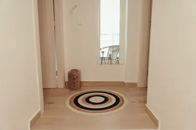 a hallway with a rug on the floor of a room at Luxury 2 storey 2bedroom condo with Private Jacuzzi & patio - Athens in Athens