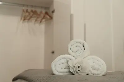 a pile of towels sitting on top of a bed at Luxury 2 storey 2bedroom condo with Private Jacuzzi & patio - Athens in Athens