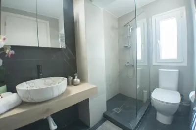 a bathroom with a sink and a toilet and a shower at Luxury 2 storey 2bedroom condo with Private Jacuzzi & patio - Athens in Athens