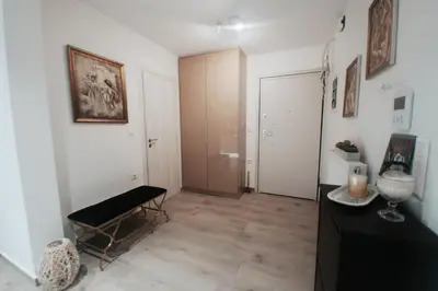a living room with a black bench and a hallway at Luxury 2 storey 2bedroom condo with Private Jacuzzi & patio - Athens in Athens