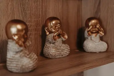 three dolls sitting on a wooden shelf with their faces in their mouths at Luxury modern chic 1-bedroom apartment Athens City in Athens
