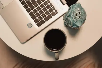a laptop and a cup of coffee on a table at Luxury modern chic 1-bedroom apartment Athens City in Athens