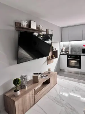a living room with a large flat screen tv on the wall at Luxury modern chic 1-bedroom apartment Athens City in Athens
